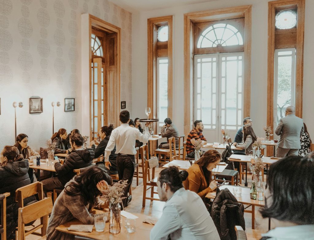a waiter walking through a busy restaurant
