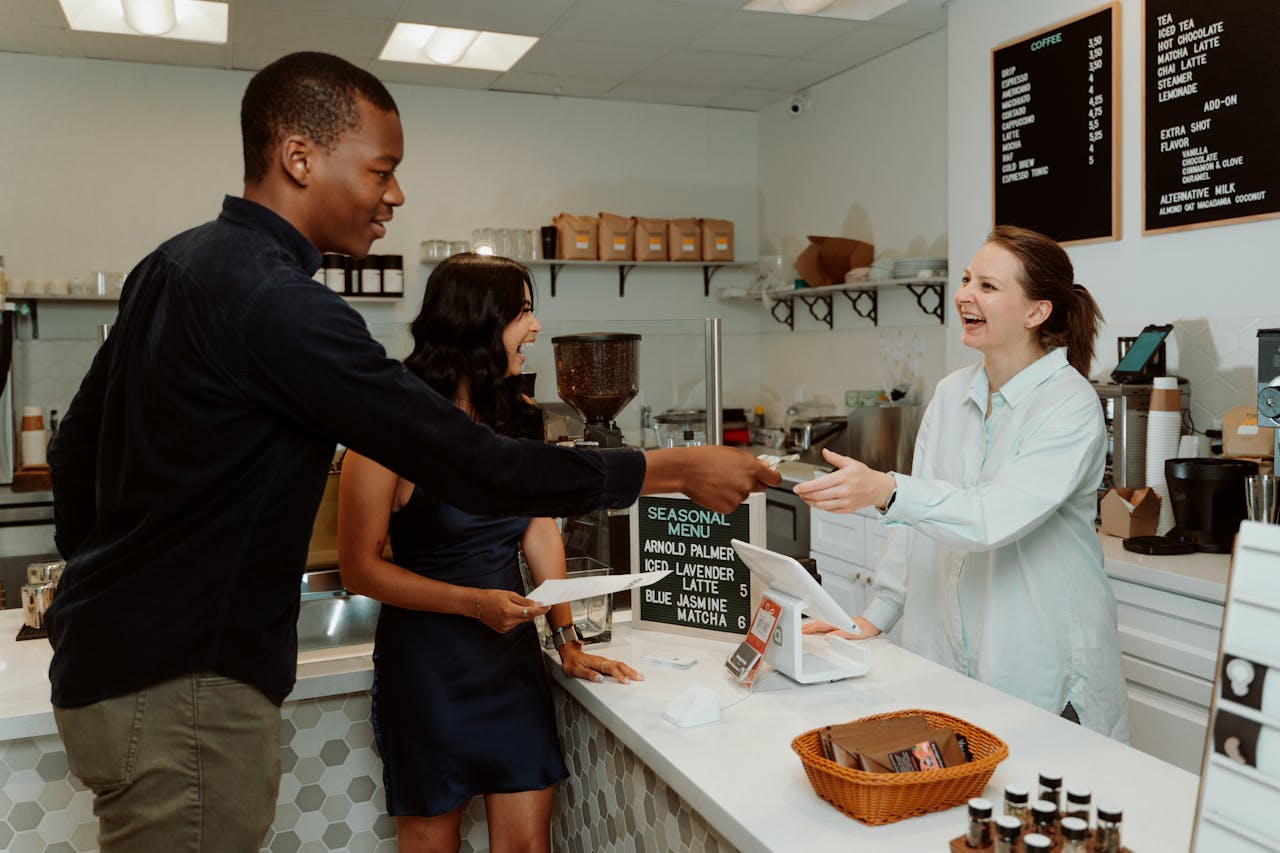 a customer purchasing something in a coffee shop