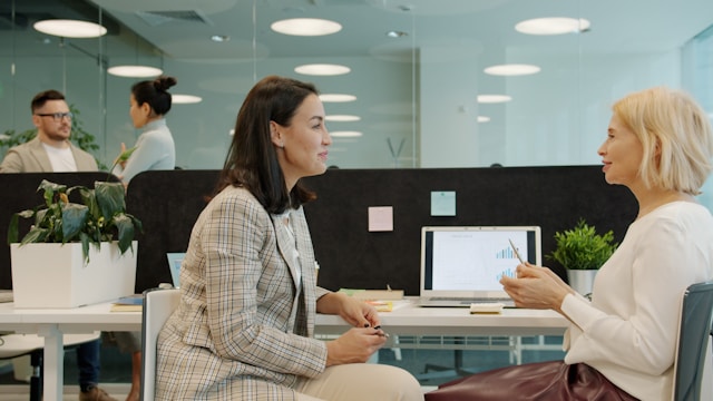 two ladies talking in an office